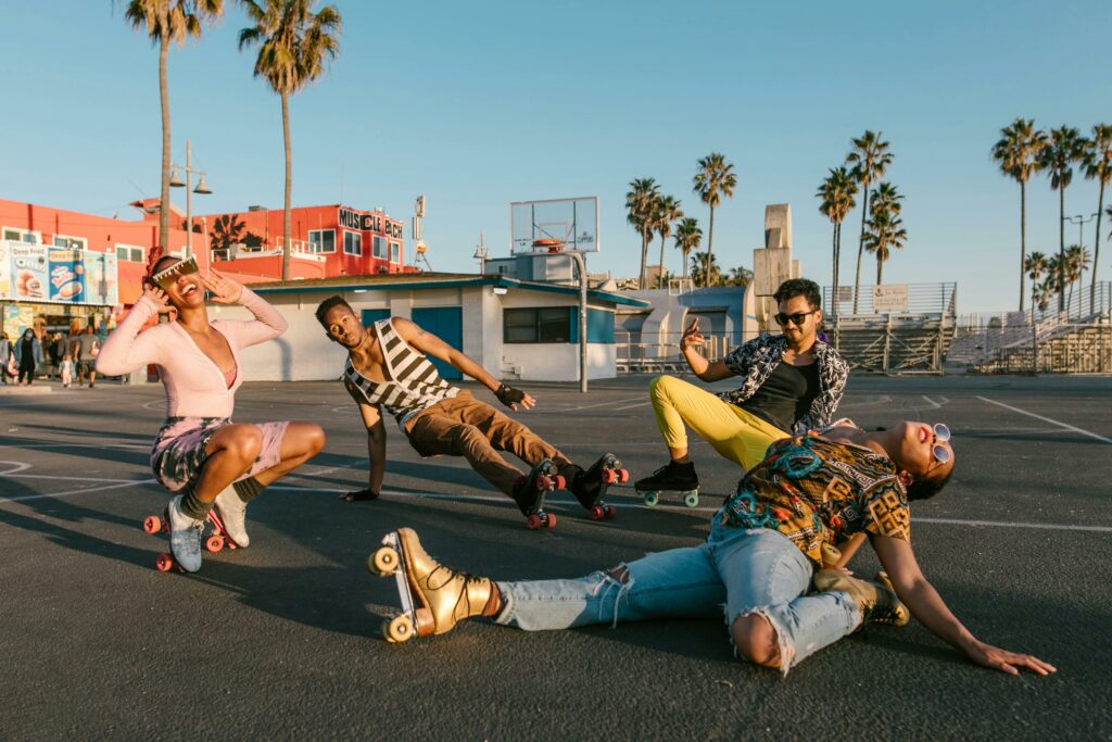 Diverse group of stylish young adults enjoying roller skating in a sunny park.
